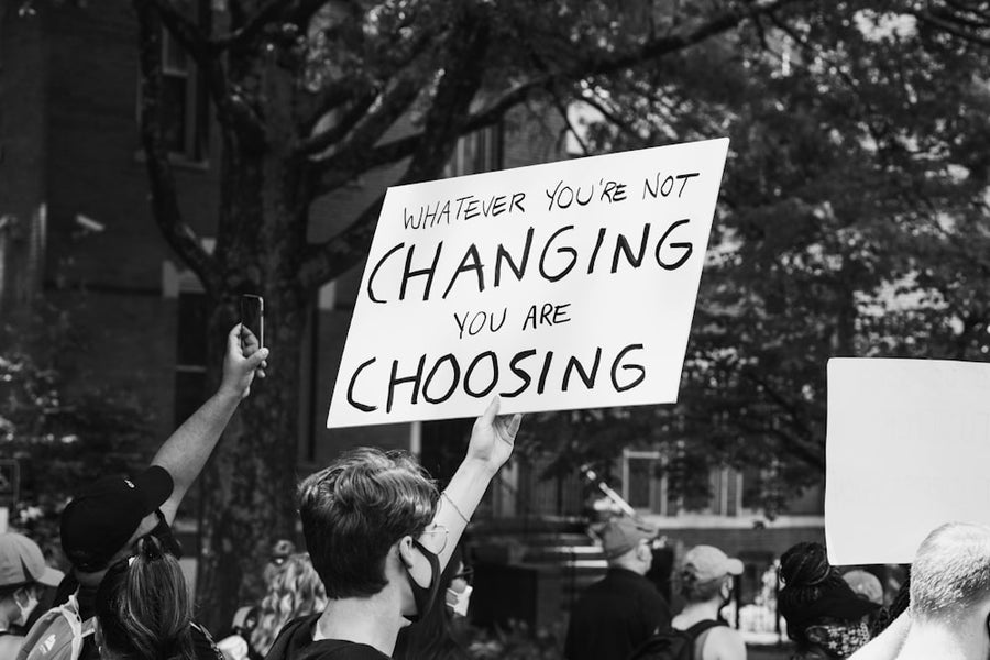 Protesters holding signs at a demonstration